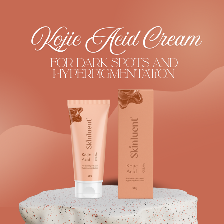 Kojie Acid Cream packaging with tube and box on a textured surface against a warm brown background